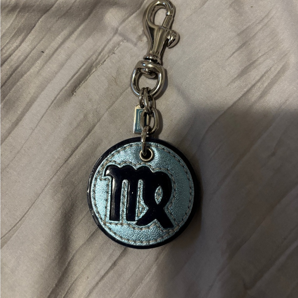 Coach metallic light/dark blue bag charm, with light pink with silver on back.